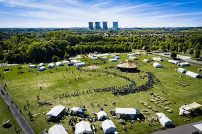 camp ground with big chimneys of a power plant in the background
