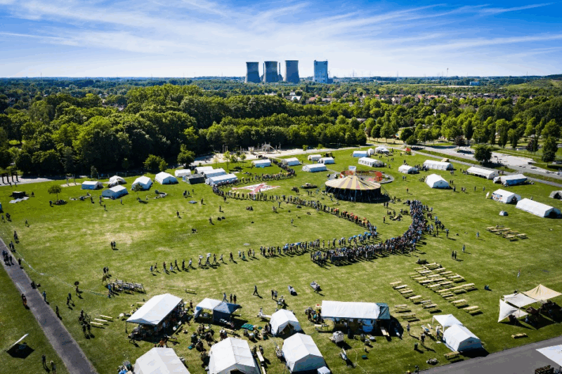 camp ground with big chimneys of a power plant in the background